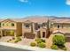 Two-story home boasts desert landscaping in the front yard, complemented by a two-car garage and mountain views in the background at 106 Rock Crossing Ave, North Las Vegas, NV 89031