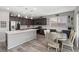 Bright eat-in kitchen features stainless appliances, dark cabinetry, and quartz countertops at 106 Rock Crossing Ave, North Las Vegas, NV 89031