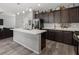 This eat-in kitchen features stainless appliances, dark cabinets, and an island at 106 Rock Crossing Ave, North Las Vegas, NV 89031
