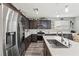 Bright eat-in kitchen boasts stainless appliances, dark cabinetry, and quartz countertops at 106 Rock Crossing Ave, North Las Vegas, NV 89031