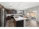 Bright eat-in kitchen features stainless appliances, dark cabinets, an island, and sliding glass doors at 106 Rock Crossing Ave, North Las Vegas, NV 89031