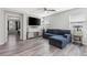 Inviting living room features sleek flooring and a comfortable blue sectional sofa at 106 Rock Crossing Ave, North Las Vegas, NV 89031