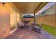 Relaxing covered patio with brick flooring, outdoor seating, and a BBQ grill at 106 Rock Crossing Ave, North Las Vegas, NV 89031