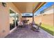 Relaxing covered patio with brick flooring, outdoor seating, and a BBQ grill at 106 Rock Crossing Ave, North Las Vegas, NV 89031