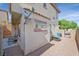 Cozy gravel backyard featuring seating, a side gate, and privacy wall at 10601 Lessona St, Las Vegas, NV 89141
