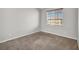 Bedroom featuring gray walls, carpet, and natural light from a window with blinds at 10601 Lessona St, Las Vegas, NV 89141