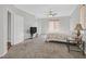 Spacious main bedroom with carpet, ceiling fan, a window with blinds and a TV at 10601 Lessona St, Las Vegas, NV 89141