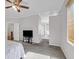 Bright main bedroom features carpet, ceiling fan, a view into the ensuite bathroom and a TV at 10601 Lessona St, Las Vegas, NV 89141