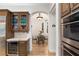 Elegant kitchen featuring a wine cooler and an arched doorway leading to the dining area at 11680 Evergreen Creek Ln, Las Vegas, NV 89135