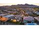 A twilight view of a community with a swimming pool and mountain views in the background at 12295 Skyracer Dr, Las Vegas, NV 89138