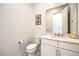Well-lit half-bathroom with a white vanity, large mirror, and modern fixtures at 12295 Skyracer Dr, Las Vegas, NV 89138