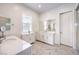 A spacious bathroom with double sinks, white cabinetry, and marble tile flooring at 12295 Skyracer Dr, Las Vegas, NV 89138