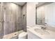 Bathroom featuring stone tile floors, glass enclosed shower, white cabinets and counters at 12295 Skyracer Dr, Las Vegas, NV 89138