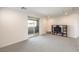 Bright bedroom with neutral carpet, a sliding glass door to the balcony, and shelving with television at 12295 Skyracer Dr, Las Vegas, NV 89138