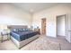 Bright bedroom with a large bed, side tables, lamps, and plush carpet at 12295 Skyracer Dr, Las Vegas, NV 89138