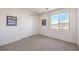 Bedroom featuring neutral carpet, natural light, and a closet with folding doors at 12295 Skyracer Dr, Las Vegas, NV 89138