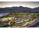 Community park featuring pickleball and basketball courts, playground, and green space with mountain views at 12295 Skyracer Dr, Las Vegas, NV 89138