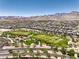 Aerial view of a well-maintained community park and green space with mountain views and residential homes at 12295 Skyracer Dr, Las Vegas, NV 89138