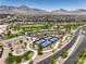 Aerial view of a community park with basketball, pickleball courts, and playground with mountain backdrop at 12295 Skyracer Dr, Las Vegas, NV 89138