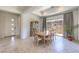 Elegant dining room featuring a large dining table with seating for ten, tile flooring, and modern decor at 12295 Skyracer Dr, Las Vegas, NV 89138
