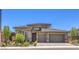 Attractive single-story home with a two-car garage, desert landscaping, and neutral color scheme at 12295 Skyracer Dr, Las Vegas, NV 89138