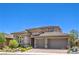 Charming single-story home with a two-car garage, desert landscaping, and modern design at 12295 Skyracer Dr, Las Vegas, NV 89138