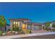 Attractive single-story home at dusk with a two-car garage and desert landscaping at 12295 Skyracer Dr, Las Vegas, NV 89138