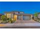Attractive single-story home at dusk with a two-car garage, desert landscaping, and neutral color scheme at 12295 Skyracer Dr, Las Vegas, NV 89138