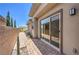 A modern home exterior featuring a private walkway and sliding glass doors that provide seamless indoor-outdoor living at 12295 Skyracer Dr, Las Vegas, NV 89138