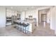 Bright, open kitchen features stainless steel appliances, island with seating, and stylish white cabinetry at 12295 Skyracer Dr, Las Vegas, NV 89138