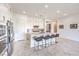 Modern kitchen featuring stainless steel appliances, a large island with bar seating, and sleek white cabinets at 12295 Skyracer Dr, Las Vegas, NV 89138