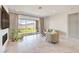 The open living room has a decorative fireplace, patio access and elegant window coverings at 12295 Skyracer Dr, Las Vegas, NV 89138