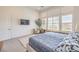 This main bedroom has large windows, carpet and an accent chair at 12295 Skyracer Dr, Las Vegas, NV 89138