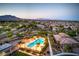 Stunning aerial view of a community pool with lounge chairs and covered cabana overlooking desert landscape at 12295 Skyracer Dr, Las Vegas, NV 89138