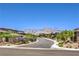 Neighborhood street view showing well-maintained homes, desert landscaping, and a mountain range in the distance at 12295 Skyracer Dr, Las Vegas, NV 89138