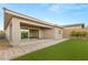 Well maintained backyard featuring a covered patio, an artificial lawn, and desert landscaping at 12550 Point Sierra St, Las Vegas, NV 89138