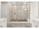 Modern bathroom featuring a large glass enclosed shower with stone flooring at 12550 Point Sierra St, Las Vegas, NV 89138