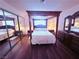 Inviting bedroom with a canopy bed, wood floors, and closet mirror at 1320 Driscoll Dr # 201, Las Vegas, NV 89128