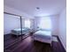Bright bedroom featuring a mirrored closet, light blue comforter, and hardwood floors at 1320 Driscoll Dr # 201, Las Vegas, NV 89128