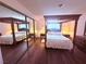 Bright bedroom showcasing a canopy bed with hardwood flooring at 1320 Driscoll Dr # 201, Las Vegas, NV 89128