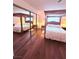 Bedroom showcases a canopy bed, mirrored closet, and wooden floors at 1320 Driscoll Dr # 201, Las Vegas, NV 89128