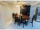 Dining room with a dark wood table, chairs, and a china cabinet with light tile floors at 1320 Driscoll Dr # 201, Las Vegas, NV 89128