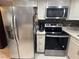 Well-equipped kitchen with stainless steel appliances including refrigerator, microwave, and range oven at 1320 Driscoll Dr # 201, Las Vegas, NV 89128