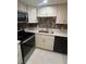 Modern kitchen featuring stainless steel appliances, sleek countertops, and stylish backsplash at 1320 Driscoll Dr # 201, Las Vegas, NV 89128