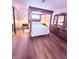 Cozy primary bedroom featuring a four-poster bed, wood floors, and classic furnishings at 1320 Driscoll Dr # 201, Las Vegas, NV 89128