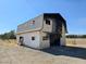 Barn exterior with a two story facade, presenting an opportunity for renovation and revitalization at 1400 Silver Peak Ave, Pahrump, NV 89048