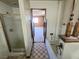 Bathroom with tub and shower featuring vintage tile and rustic decorative elements at 1400 Silver Peak Ave, Pahrump, NV 89048