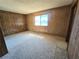 Bedroom featuring wood paneled walls, a window, and lots of natural light at 1400 Silver Peak Ave, Pahrump, NV 89048