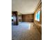 Spacious bedroom with a closet, window, and wood-paneled walls at 1400 Silver Peak Ave, Pahrump, NV 89048