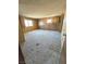 Bedroom featuring two windows providing natural light, and wood-paneled walls at 1400 Silver Peak Ave, Pahrump, NV 89048